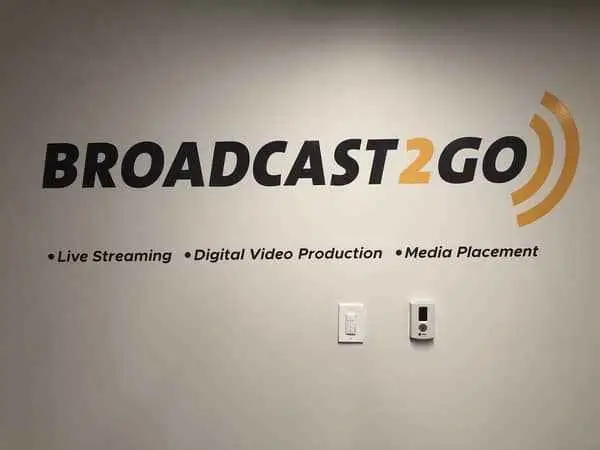 Wall display for Broadcast2Go, highlighting services: Live Streaming, Digital Video Production, and Media Placement.